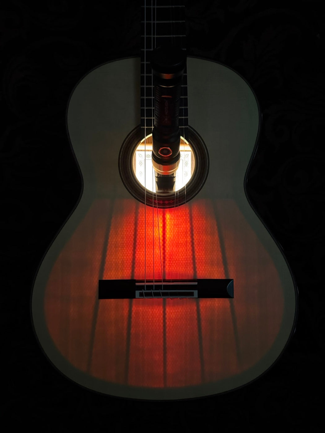 A soundboard glowing from within, revealing its bracing