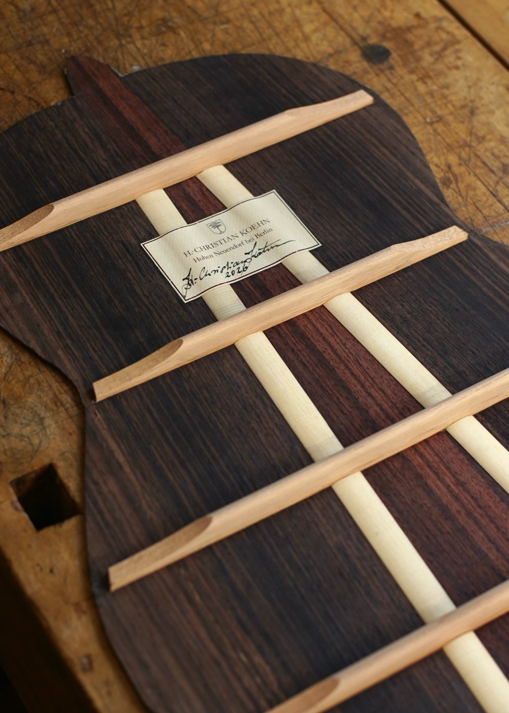 The braced rosewood back, signed and labeled
