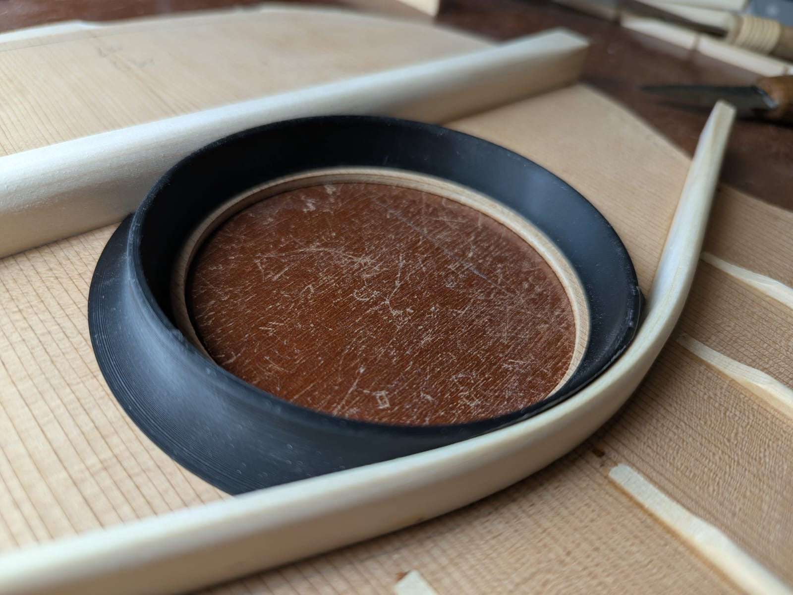 The soundhole ring under its clamp