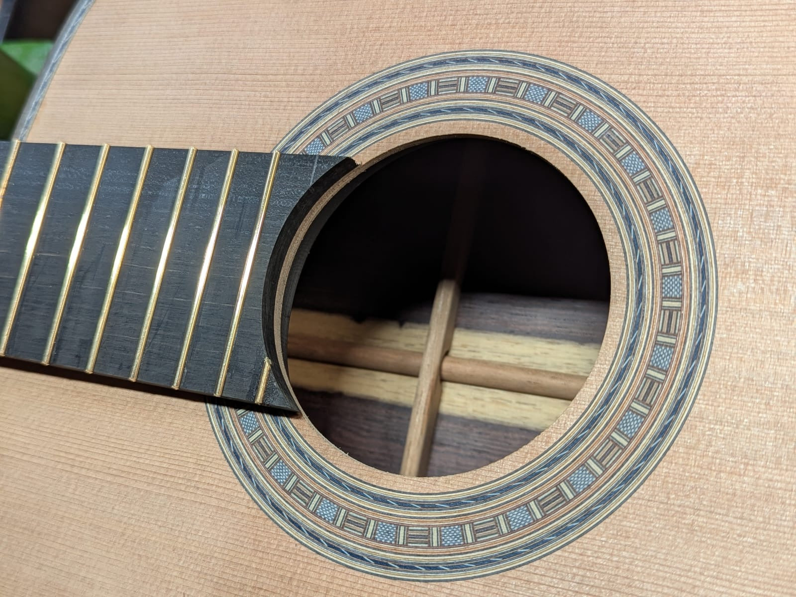 The finished rosette beneath the fresh fingerboard