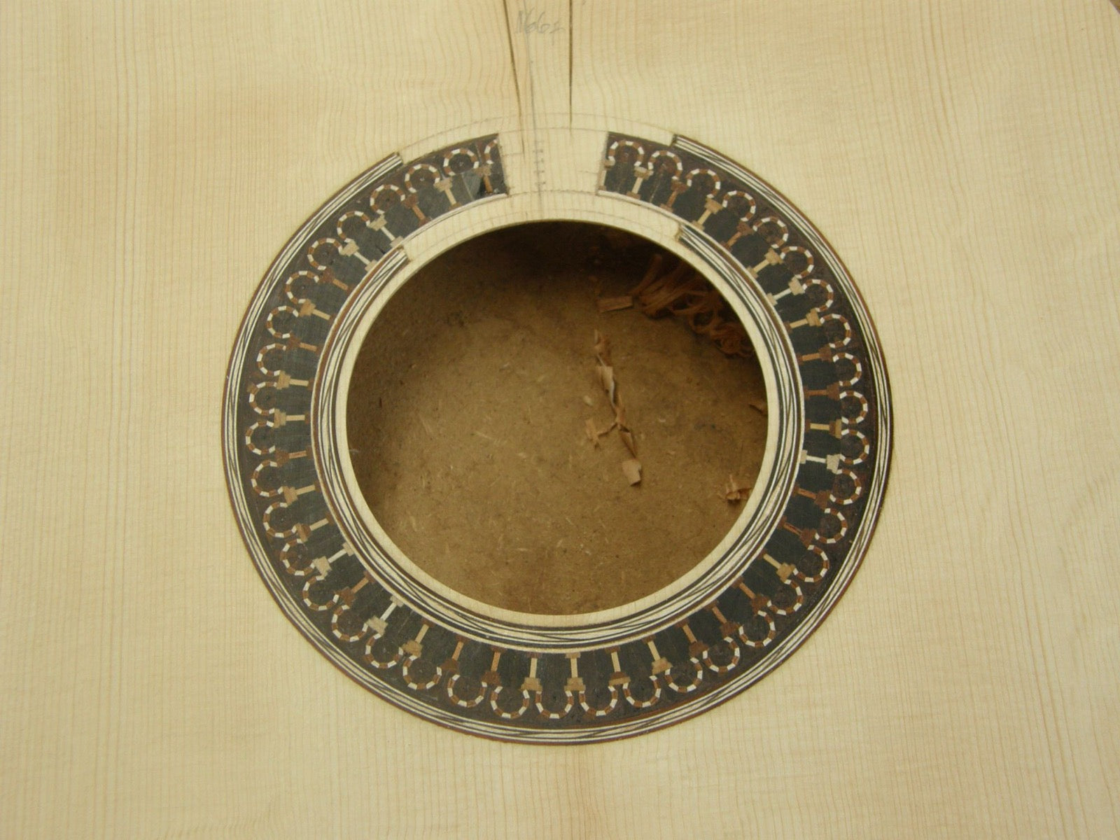 His Romanillos inspired rosette, set into the raw soundboard